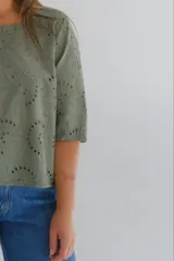 Blusa verde militar con calados circulares, escote cuadrado y mangas 3/4.