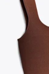 Top marrón de punto con escote cuadrado y tirantes anchos.