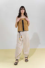 Top de lino color beige con breteles anchos y silueta cuadrada. Presenta una pieza aplicada en la delantera con detalle de vainillas en los laterales y frunce en el escote de la espalda.
