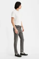 Pantalón de jean gris oscuro, corte skinny, tiro medio y confeccionado en tejido rígido.
