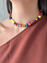 Collar corto con cuentas de cristal checo, cerámica, madera y otros materiales. Se cierra con cadena y ganchito para regular el largo.