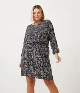 Vestido corto de viscosa con estampado de corazones, cuello redondo, manga larga, elástico en la cintura y botón en el puño.