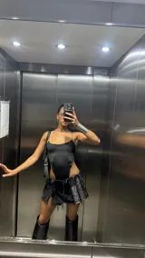 Pollera negra de mezclilla con desgastes y detalles de rotura.