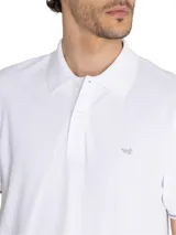 Chomba azul marino de piqué de algodón pima peruano, con cuello clásico, tapeta de dos botones blancos, mangas cortas con ribete rosa y logo de la marca bordado en el pecho.