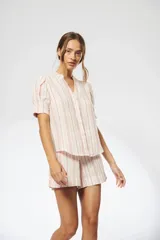 Camisa de lino rayada en tonos claros con escote en V, mangas cortas con detalle de tablas, y botones ocultos.