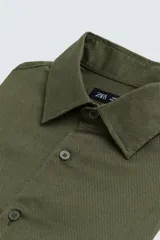 Camisa blanca de corte regular, cuello italiano, manga larga con puños abotonados y cierre frontal con botones.