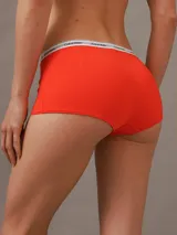 Bombacha hípster color naranja de algodón elástico, con cintura elástica blanca con logo Calvin Klein.