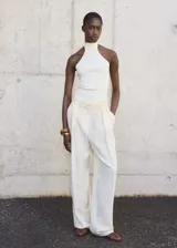 Top blanco de punto fino con cuello halter y diseño entallado.