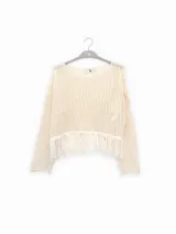 Sweater tejido italiano de algodón con punto abierto y sutil brillo de lúrex, con detalles de flecos.