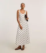 Vestido midi de corte evasé, sin mangas y escote cuadrado, confeccionado en viscolino bicolor blanco y negro con estampado de lunares.