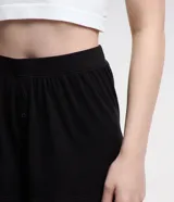 Short de pijama negro de ribana con cintura elástica y botones decorativos.