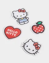 Set de cuatro pines de acrílico con diseños de Hello Kitty y una manzana roja con lunares blancos.