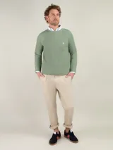 Sweater verde de punto inglés, con cuello redondo y logo bordado en el pecho. Corte regular fit.