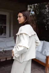 Campera de jean gris oscuro con volados en el frente y las mangas, de corte recto y largo a la cadera.