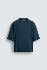 Camiseta azul marino de corte cuadrado (boxy fit), cuello redondo y manga corta. Presenta costuras a la vista en el frente y la espalda.