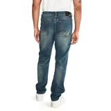 Pantalón de jean color verde militar, de corte slim, con cinco bolsillos y logo CAT en la parte trasera.