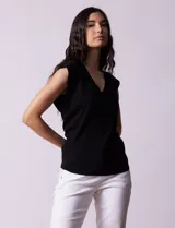 Buzo tejido en hilado fino color beige, con escote en V y sin mangas.