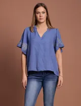 Blusa azul de crepe marca Batía, con cuello a la base y escote en V. Manga corta amplia con bordados en los extremos.
