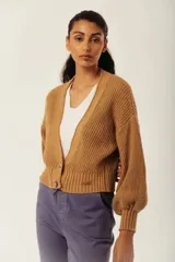 Cárdigan color marrón con tejido de punto acanalado, escote en V, cierre frontal con botones y mangas largas abullonadas.