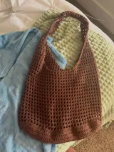 Bolso de hombro tejido al crochet color crema, con diseño calado.
