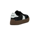 Zapatillas urbanas negras con detalle de una franja blanca en el lateral y suela marrón.