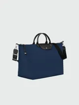 Bolso de viaje negro de Longchamp, de gran capacidad, con asas cortas y diseño plegable.