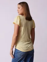 Remera tejida color amarillo, marca French Loundry. Manga corta con detalle de puntilla.