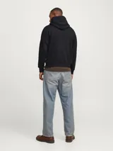 Canguro negro con capucha y cordones ajustables, de manga larga y corte relajado. Estampado frontal con texto "ORIGINALS MSTUDIO" en color ladrillo.