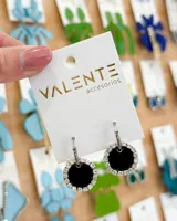 Aros colgantes con aro de acero plateado y pieza circular negra con borde de strass plateado.