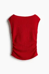 Top entallado rojo en punto con textura. Modelo con escote bote, manga japonesa y costuras laterales fruncidas para un efecto drapeado suave.