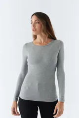 Remera gris de punto canalé, con escote redondo y mangas largas.