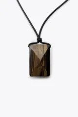 Collar con cordón de cuero negro y colgante de piedra facetada color verde oscuro.