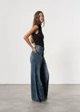 Pantalón de jean color crudo, de corte mega wide leg y tiro alto.