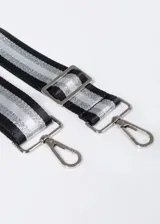 Correa ajustable para cartera en tonos negro y gris, con detalles en metal y diseño elegante.