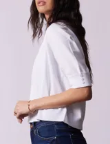 Bolero tejido blanco de manga corta con apliques de botones en los puños.