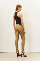 Jean slim color dorado metalizado, de tiro medio y largo al tobillo.