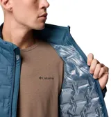 Campera puffer para hombre marca Columbia, modelo Delta Ridge II Down en color azul. Presenta tecnología Omni-Heat™ con forro termorreflectante, construcción HeatSeal™ sin costuras con diseño acolchado geométrico y tejido repelente al agua Omni-Shield™. Cuenta con aislamiento de plumón de 650 hilos, cierre frontal completo, cuello alto con protección de barbilla y bolsillos laterales con cremallera.