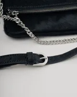 Bandolera plateada de cuero con solapa frontal y correa combinada de cuero y cadena metálica. Incluye una correa desmontable y regulable en cuero con eslabones metálicos.