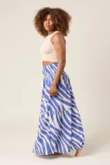 Falda larga con estampado de cebra en tonos marrón y blanco, cintura elastizada tipo smock con cordón ajustable y terminación en borlas.