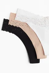 Pack de tres colaless de algodón con cintura de encaje: una negra, una color piel y una blanca.