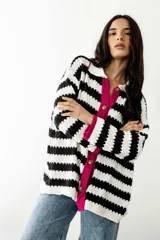 Camisa tejida a rayas horizontales blancas y negras, con cuello camisero blanco, botones marrones y ribete fucsia.