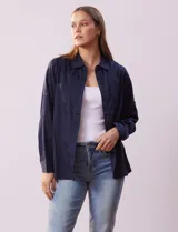 Camisa blanca de lyocell, marca Dash. Tiene cuello con solapa, abertura central con botones, mangas largas regulables con presilla y botón, y dos bolsillos delanteros aplicados.