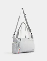 Bolso deportivo acolchado color celeste con bolsillo frontal con cierre, correa regulable y desmontable, y manija superior.