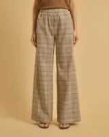 Pantalón de lino y algodón a cuadros color beige, de corte recto y tiro medio, con cintura elástica y bolsillos laterales.