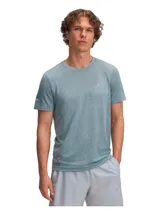 Remera deportiva Under Armour Seamless Stride para hombre, color verde oscuro con logo plateado en el pecho y detalles reflectantes en las mangas. Confeccionada con tejido transpirable y tecnología anti-olor.