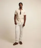 Camisa de hombre de manga corta confeccionada en una mezcla de lino y algodón, marca Marfinno. Presenta un calce confort, cuello clásico, cierre frontal con botones y un bolsillo de parche con solapa en el pecho. Las mangas cuentan con un detalle de dobladillo.