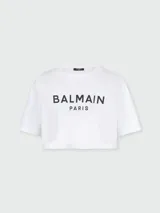 Remera corta blanca de algodón con estampado del logo Balmain Paris en negro en el pecho.
