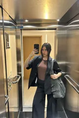 Blazer negro de corte clásico con mangas 3/4 y cierre con botones.