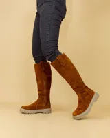 Bota alta de cuero negro con suela track y cierre lateral.