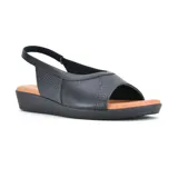 Sandalia Usaflex de cuero negro con paneles textiles, taco corrido y tira trasera.